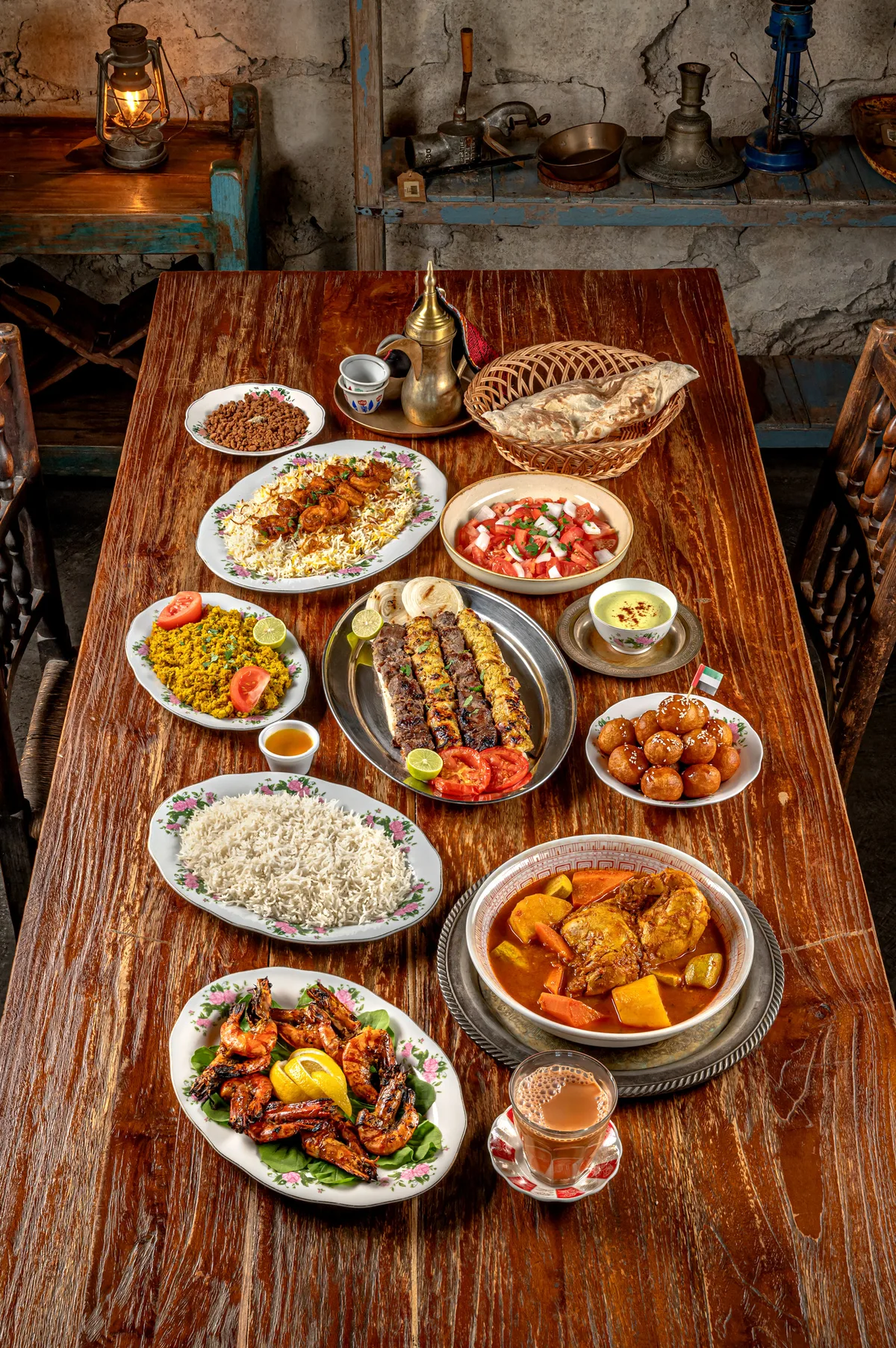 A long wooden table of Emirati dishes, seen from above