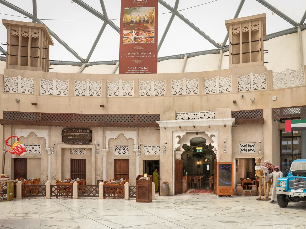 The Yas Mall branch: a heritage front with wind towers under the mall's glass roof
